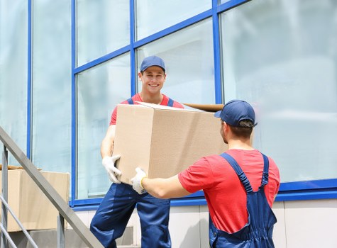 Office desks and business items arranged for transport during a local move
