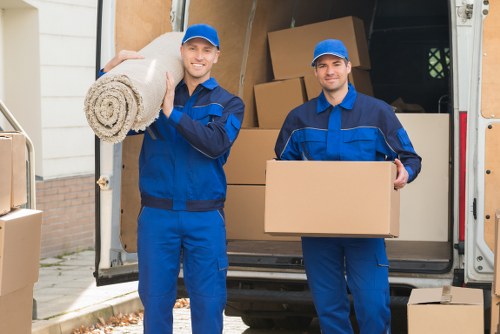 Removal van and moving team in a Hampstead residential street